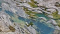 Emerald green pools of water in pockets of eroded rock formation