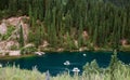 Emerald Lake Oasis Tranquil waters, lush hills, small boats, mountain backdrop