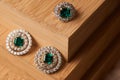 Emerald ring and pair of diamond earrings in gold Royalty Free Stock Photo