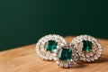 Emerald ring and pair of diamond earrings in gold Royalty Free Stock Photo