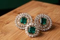 Emerald ring and pair of diamond earrings in gold Royalty Free Stock Photo