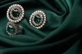 Emerald ring and pair of diamond earrings in gold Royalty Free Stock Photo