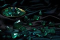emeralds scattered on dark velvet surface Royalty Free Stock Photo