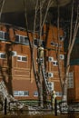 An EMERCOM employee stands on the stairs and extinguishes a fire at night in winter