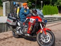 An Emergencies Ministry employee sits on a specialized motorcycle of the fire service