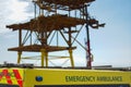 Emergency ambulance by oil rig. Maritime health and safety. Royalty Free Stock Photo