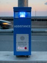 Emergency assistance phone on a bridge, dusk