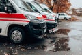 Emergency car, red and white ambulance medical service vehicle on a street in big city.