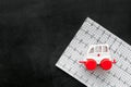 Emergency care concept. Ambulance vehicle toy near cardiogram on black background top view copy space