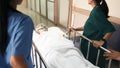 Emergency Department. Nurse and senior doctor team busy push emergency stretcher transport senior patient in hospital Royalty Free Stock Photo