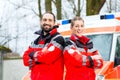 Emergency doctor in front of ambulance car