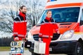 Emergency doctor in front of ambulance