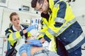 Emergency doctor giving cardiac massage for reanimation in ambulance