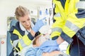 Emergency doctor giving cardiac massage for reanimation in ambulance Royalty Free Stock Photo