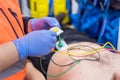 Emergency doctor hands, attaching ecg electrodes on patient chest in ambulance Royalty Free Stock Photo