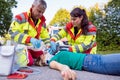 Emergency doctor ventilating injured woman after motorbike accident Royalty Free Stock Photo