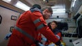 Emergency doctors performing first aid help to man in emergency car