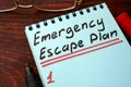 Emergency Escape Plan written on a notepad.