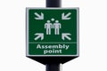 Emergency evacuation assembly point sign close up isolated against white background.