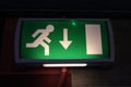 Emergency exit backlit green sign Royalty Free Stock Photo