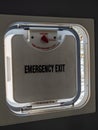 Emergency exit hatch partially open in a bus with latch and daytime Royalty Free Stock Photo