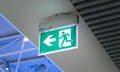 Emergency exit sign in an airport. Public safety, evacuation concept Royalty Free Stock Photo