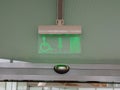 emergency exit sign for disabled people in business center, airport Royalty Free Stock Photo