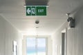 Emergency exit sign / Fire Extinguisher on the corridor in hotel or office building Royalty Free Stock Photo