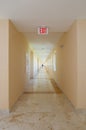 Emergency exit sign in hallway Royalty Free Stock Photo