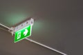 Emergency exit sign with right arrow in department store underground car parking.