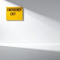 Emergency Exit Sign on a Stark White Wall with Shadows Royalty Free Stock Photo