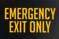 Emergency exit only yellow door sign Royalty Free Stock Photo