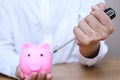 Emergency finance and Reserve money concept, Man using tools to destroy pink piggy bank