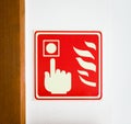 Emergency fire alarm safety call point sign on a wall. Royalty Free Stock Photo