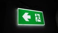 Emergency fire exit sign direction to doorway in the building green color and narrow Royalty Free Stock Photo