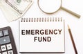 Emergency Fund text written on notebook. Financial concept