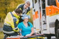 Emergency medics dressing head wound of injured woman Royalty Free Stock Photo