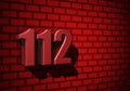 112 emergency number on dark wall Royalty Free Stock Photo