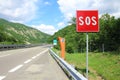 Emergency phone and sos sign on road Royalty Free Stock Photo