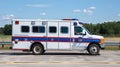 Emergency response vehicle speeding with motion blur on city street for urgent medical assistance. Royalty Free Stock Photo