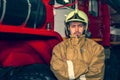 Emergency safety. Protection, rescue from danger. Fire fighter in protective helmet. Fire truck ready to respond to emergency, Royalty Free Stock Photo