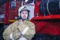 Emergency safety. Protection, rescue from danger. Fire fighter in protective helmet. Fire truck ready to respond to emergency, Royalty Free Stock Photo