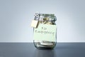 For Emergency savings written on the jar with dollars banknotes money. Royalty Free Stock Photo