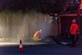 Emergency services repairing burst water main. Royalty Free Stock Photo