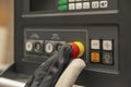 Emergency shutdown button in production. The CNC operator presses the emergency button on the control panel of the CNC Royalty Free Stock Photo