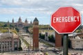 Emergency sign on Spanish square in Barcelona background. Financial crash in world economy because of coronavirus. Global economic