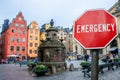 Emergency sign on Stockholm old town background. Financial crash in world economy because of coronavirus. Global economic crisis,