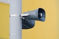 Town broadcast speaker siren in residential area in small city.