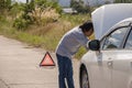 Emergency stop sign and driver near broken car on road Royalty Free Stock Photo