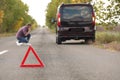 Emergency stop sign and driver near broken car Royalty Free Stock Photo